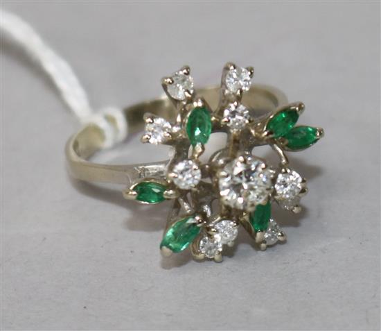 An 18k white gold, emerald and diamond cluster dress ring, size O.